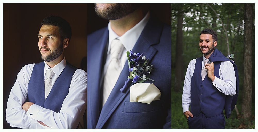 Groom smiles at camera, surrounded by groomsmen in navy suits and burgundy ties, outdoors.