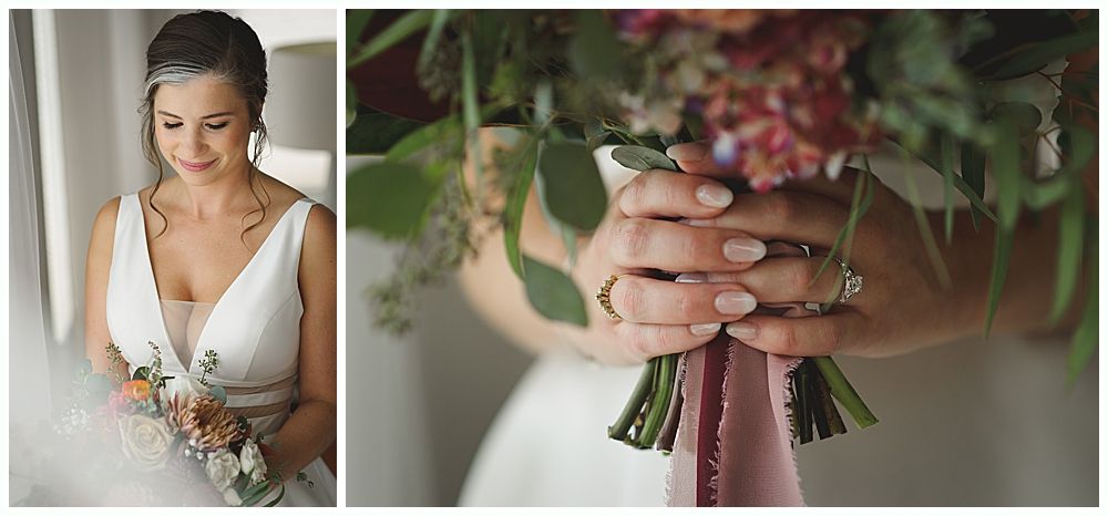 Bride in a white wedding dress smiles, holding a bouquet. A veil flows in the wind under a weeping willow.