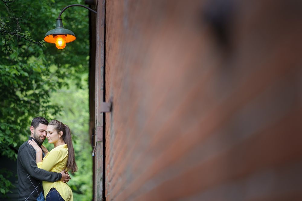 Wedding couple in forest; one embraced, one poses.