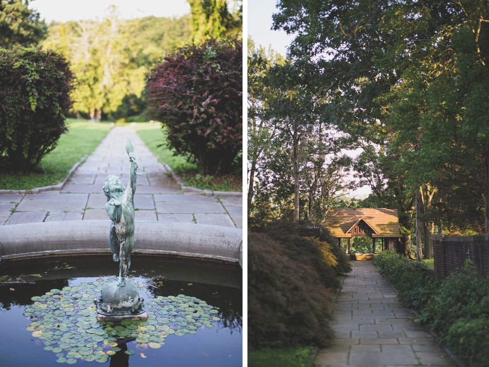 Two garden paths. One with a fountain and statue, the other leading to a building. Green foliage surrounds both.