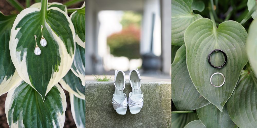 Bride and groom under umbrella, backlit by light. Mountain backdrop in dark, black and white photo.