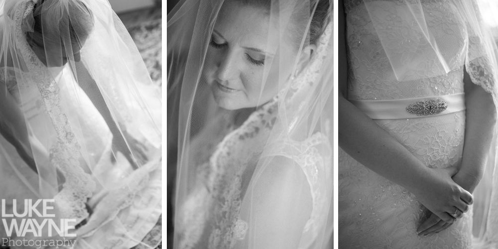 Bride in wedding dress, veil covers her face. Black and white photo.