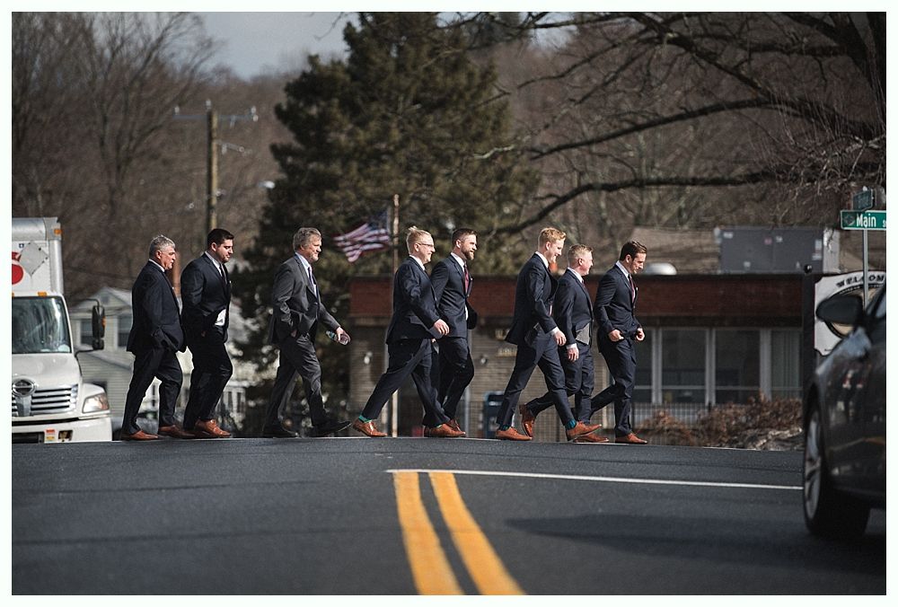 Wedding décor: seating chart, floral garlands, welcome sign, bar with disco ball lighting.