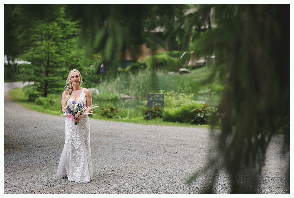 Wedding décor: seating chart, floral garlands, welcome sign, bar with disco ball lighting.