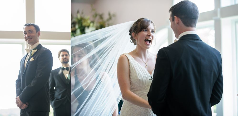 Bride and groom in wedding attire walking and kissing on a tree-lined road.