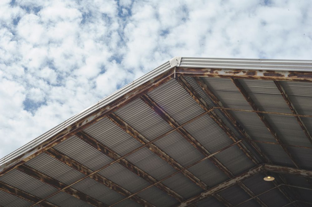A windmill, weeping willow, and gazebo in a lush garden setting.