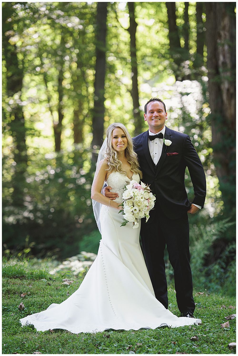 Wedding décor: seating chart, floral garlands, welcome sign, bar with disco ball lighting.