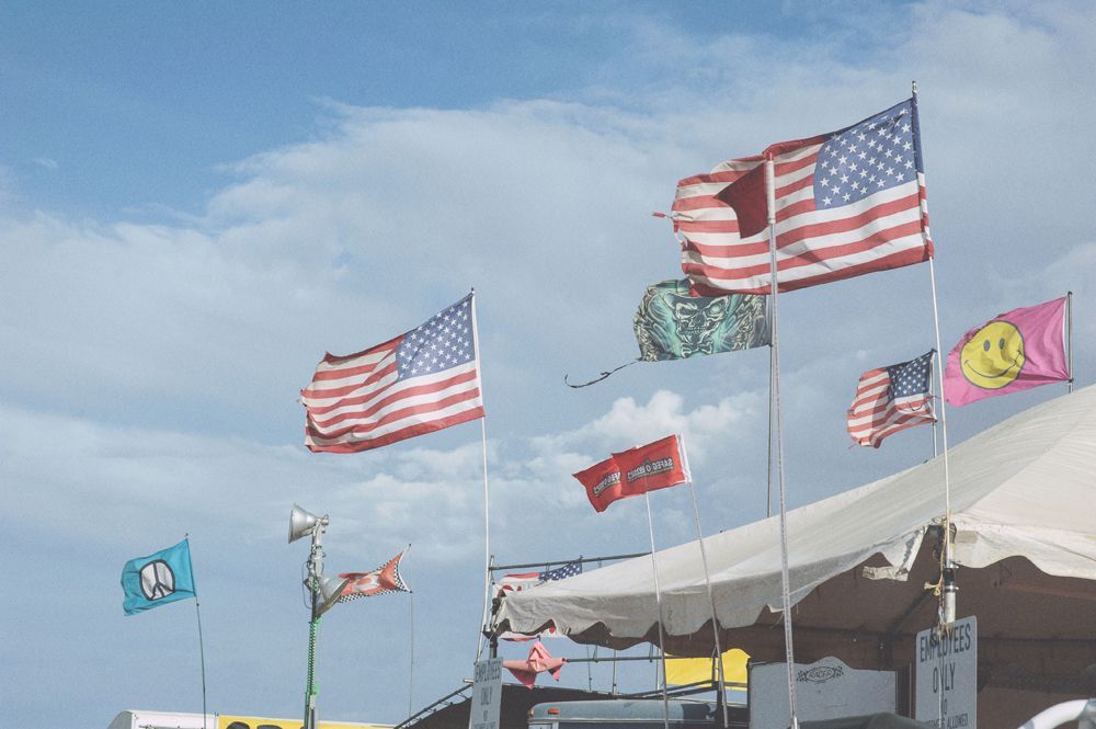 Wedding ceremony: couple at the altar, guests watching. Outdoor setting.