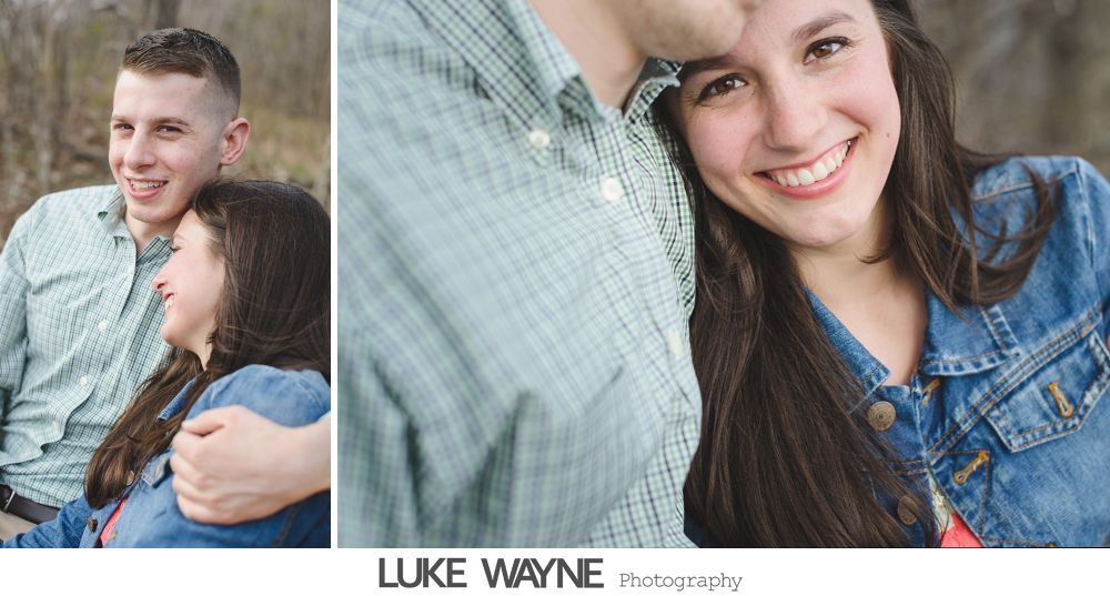 Couple smiling, embracing. Woman in denim jacket, man in light green shirt, outdoors.
