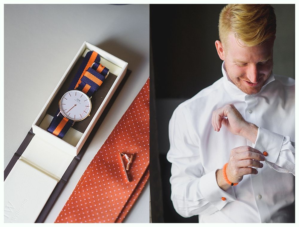 Man putting on cufflink; watch and tie with orange accents in box.