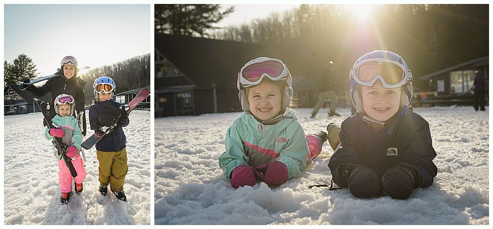 Two children in snow gear, smiling in the snow. Sun shines brightly behind them. Family poses in the snow.