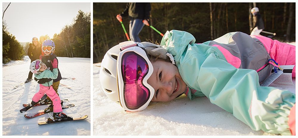 Child on snow skis, smiles, with goggles and helmet. Another child and adult stand behind.