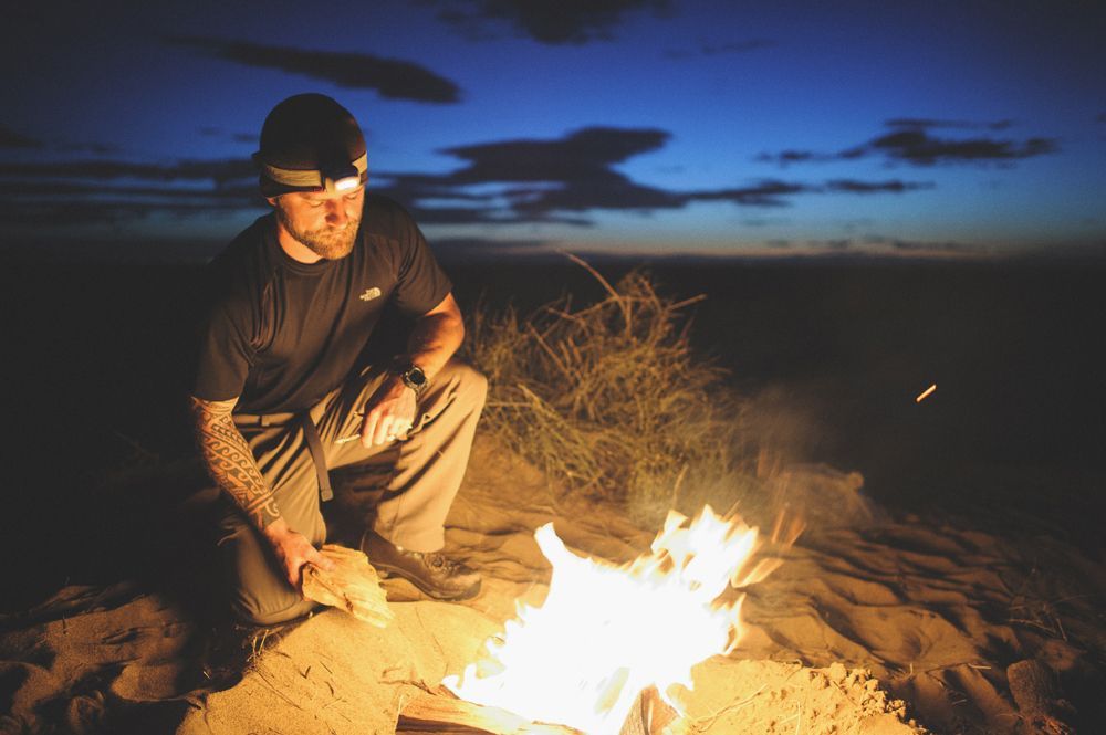 Bride and groom dancing, in a ballroom with draped windows. The groom wears a suit; the bride a strapless dress.