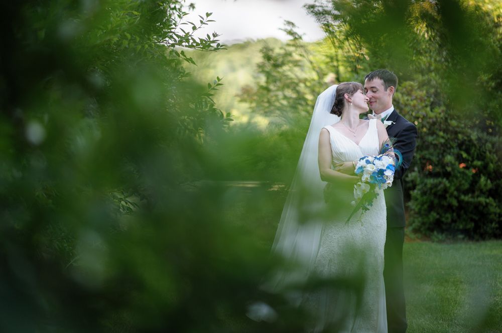 Wedding tables decorated with sunflowers, yellow boxes, and white linens.