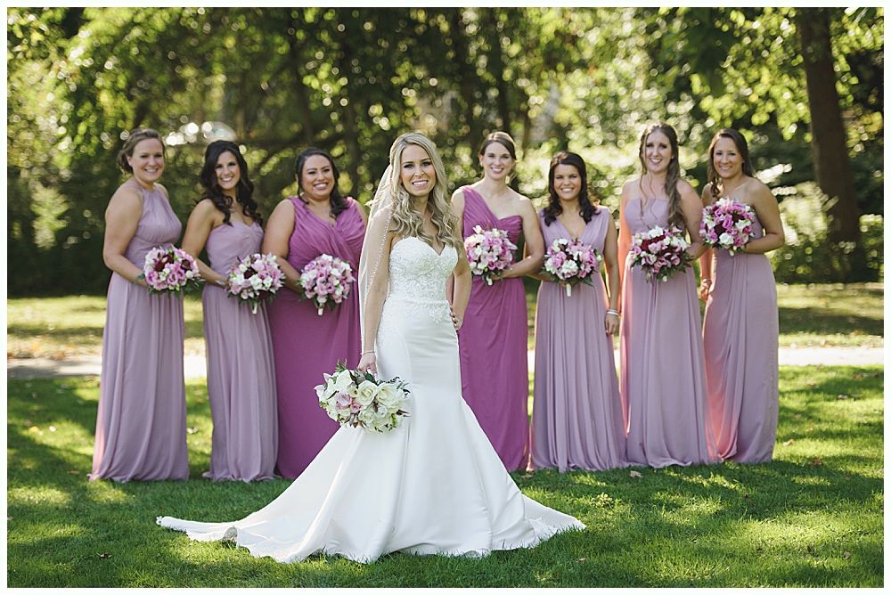 Couple embracing, noses touching, looking at each other. Snowy outdoor setting. Woman's hand with engagement ring visible.