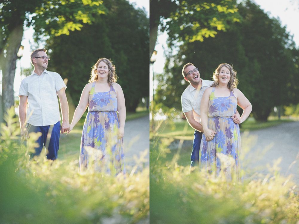 Bride and groom under umbrella, backlit by light. Mountain backdrop in dark, black and white photo.