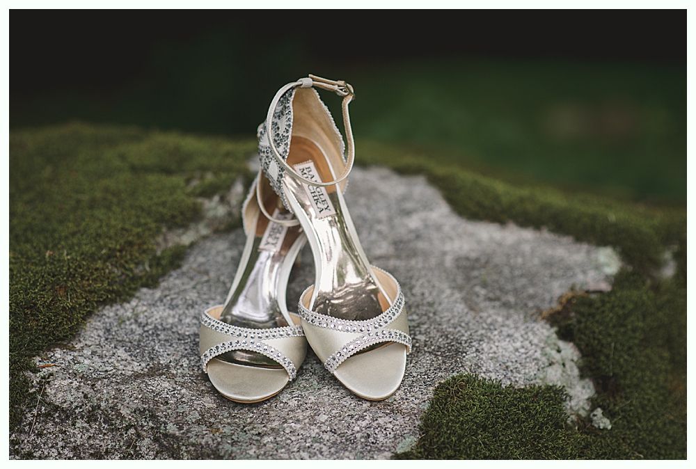 Woman holding a glass, smiling. Another woman is visible in the background, also smiling. Black and white.