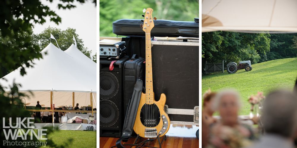 Bass guitar leaning against equipment near an outdoor event with a white tent and a green lawn.