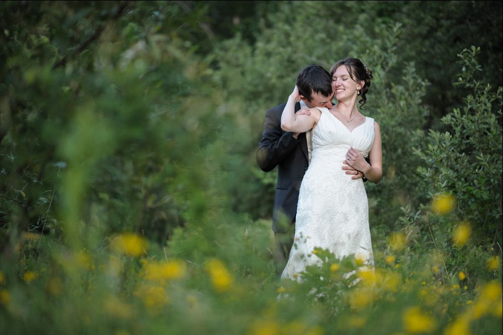Person taking photo in mirror, indoors; black and white.