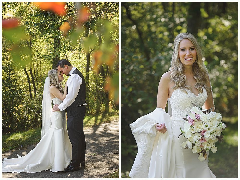 Wedding party poses outdoors. Groomsmen in navy suits, bridesmaids in red dresses, bride in white dress, holding bouquets.