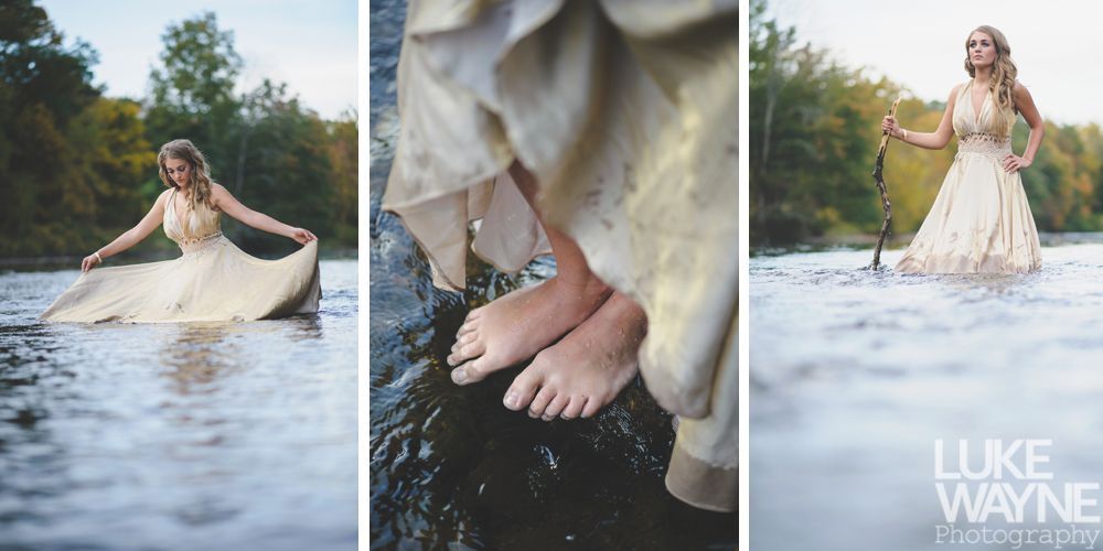 Couple embraces, overlooking a scenic valley. Woman looks toward man; both are seated. Black and white photo.