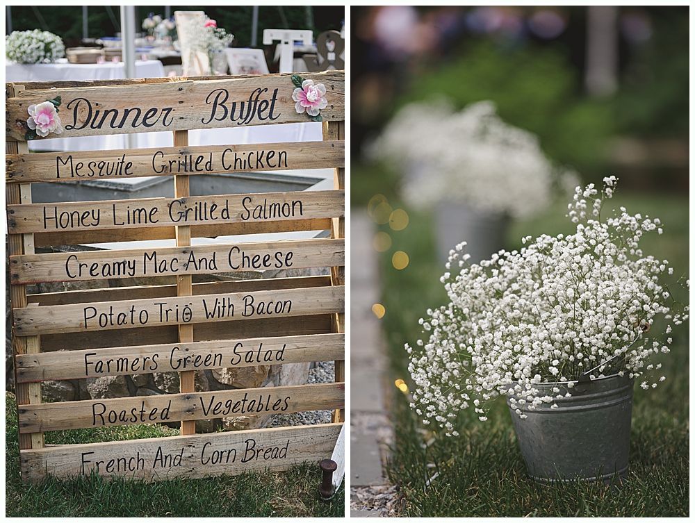 Bride and groom pose near a tree and pond. Bride in lace dress holds bouquet. Groom embraces her from behind.