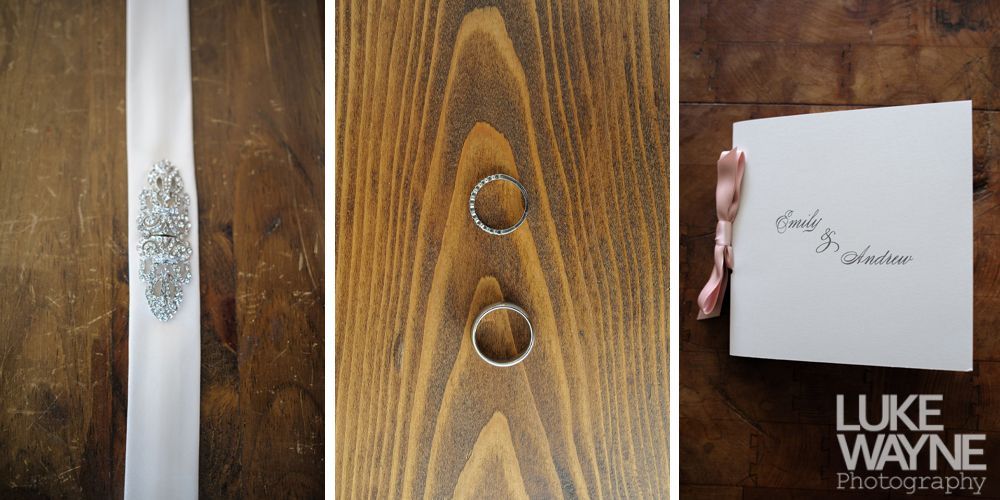 Wedding rings and a thank you card on a wooden surface. Ribbon with a jeweled design is also present.
