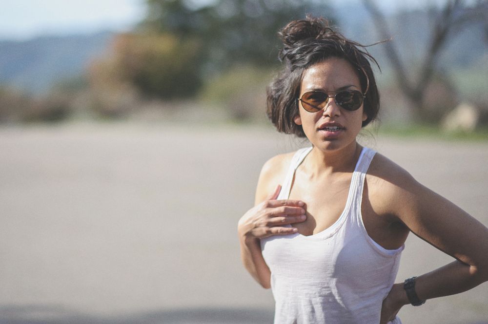 Man in suit stands in hotel hallway, smiling.