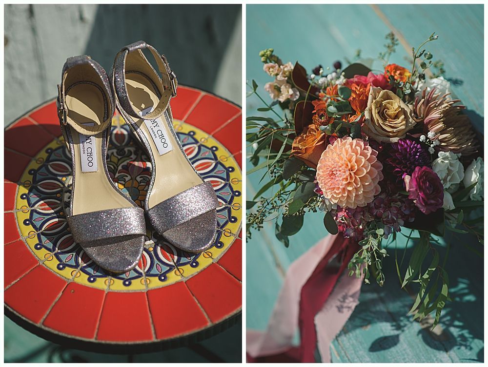 Bride in a white lace dress with veil, smiling, holding a bouquet of burgundy and green flowers.