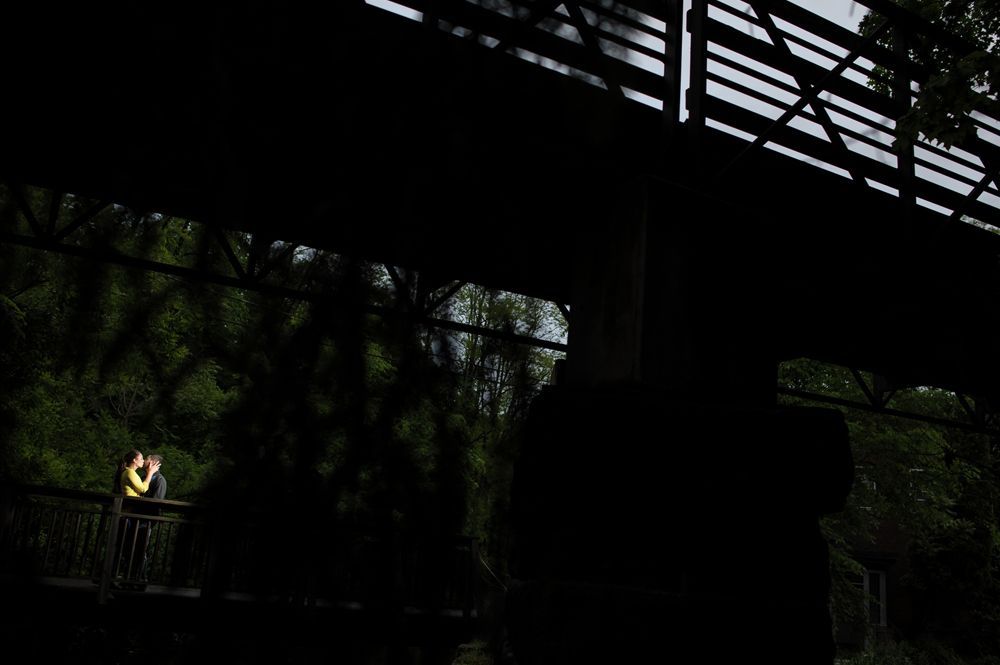 Man in suit stands in hotel hallway, smiling.