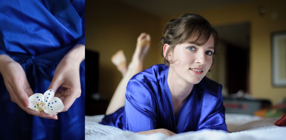 Man in suit looks out a window, checking his watch, waiting. Black and white.