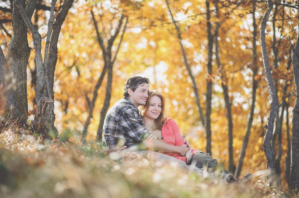 Man in suit stands in hotel hallway, smiling.