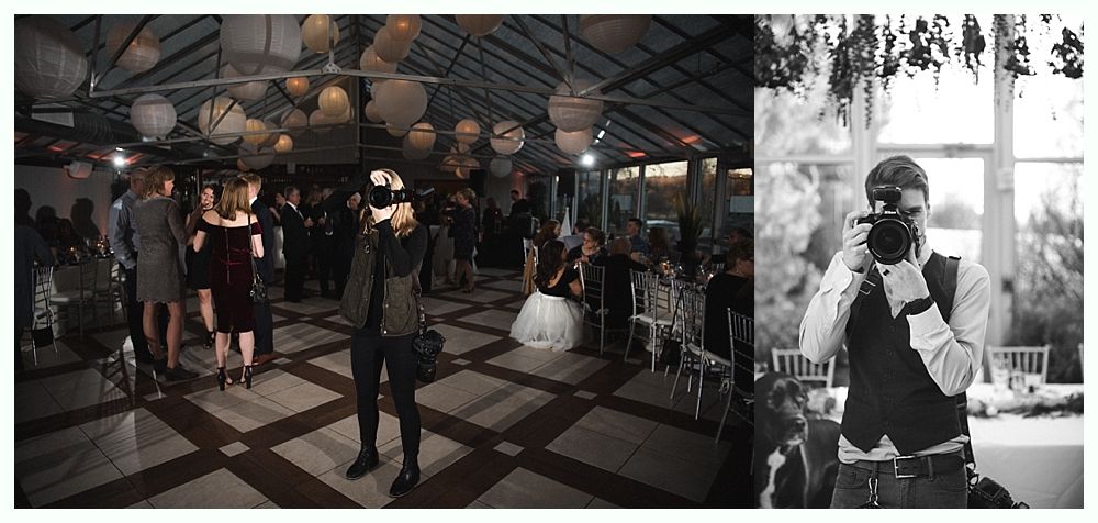 Wedding cake with figurines, on a wood slice. Rustic decor with blurred lights in the background.