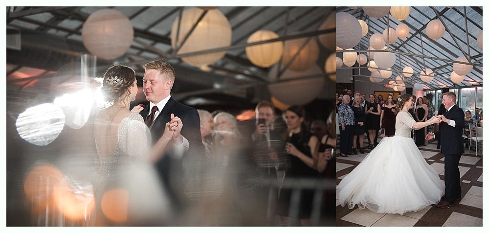 Wedding cake with figurines, on a wood slice. Rustic decor with blurred lights in the background.