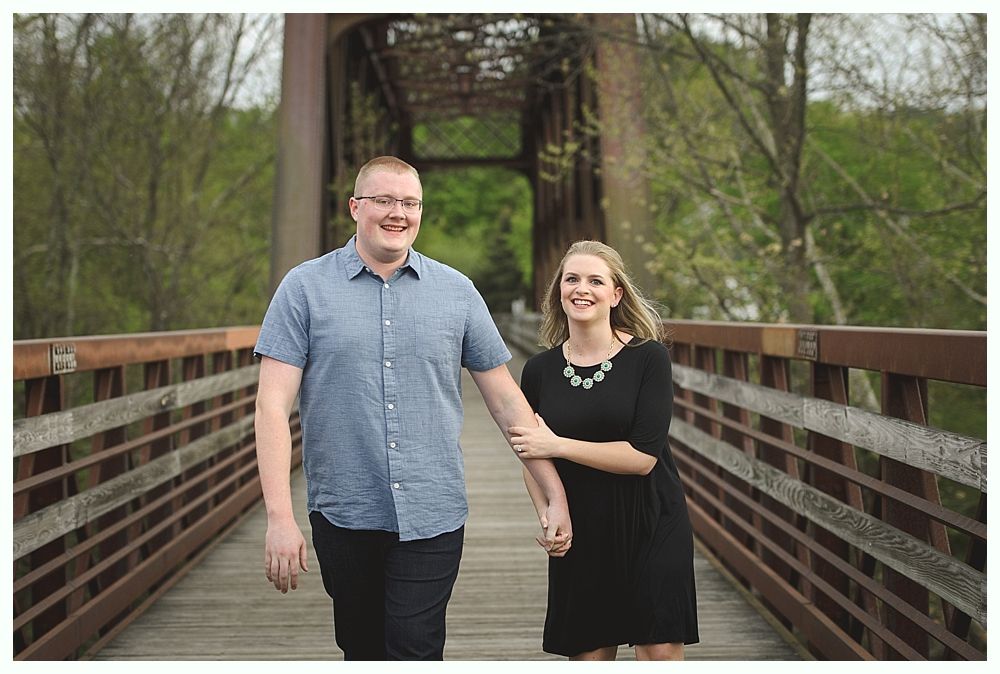 Bride facing camera, blurred. Two women, one smiling, one on phone, observe in a room.