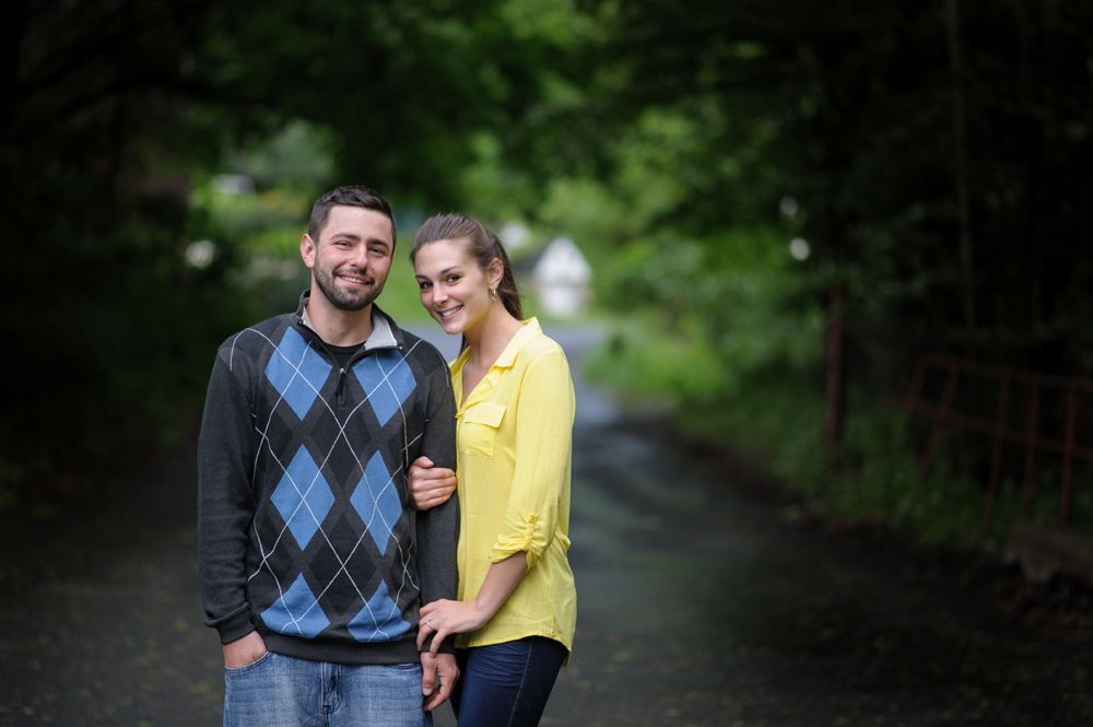 Bride facing camera, blurred. Two women, one smiling, one on phone, observe in a room.