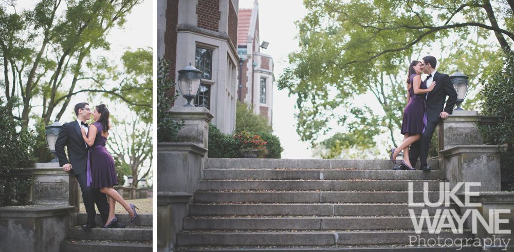 Couple kissing on steps near a building with trees. She wears purple, he's in a suit.