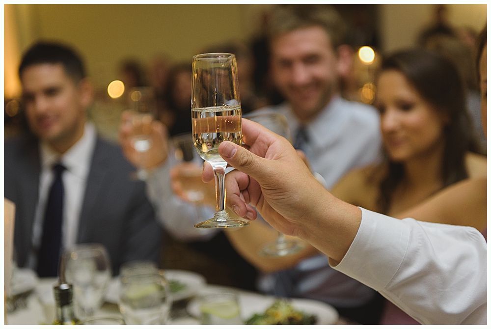 Couple dancing closely, man with surprised expression, woman laughing, party setting with lights.