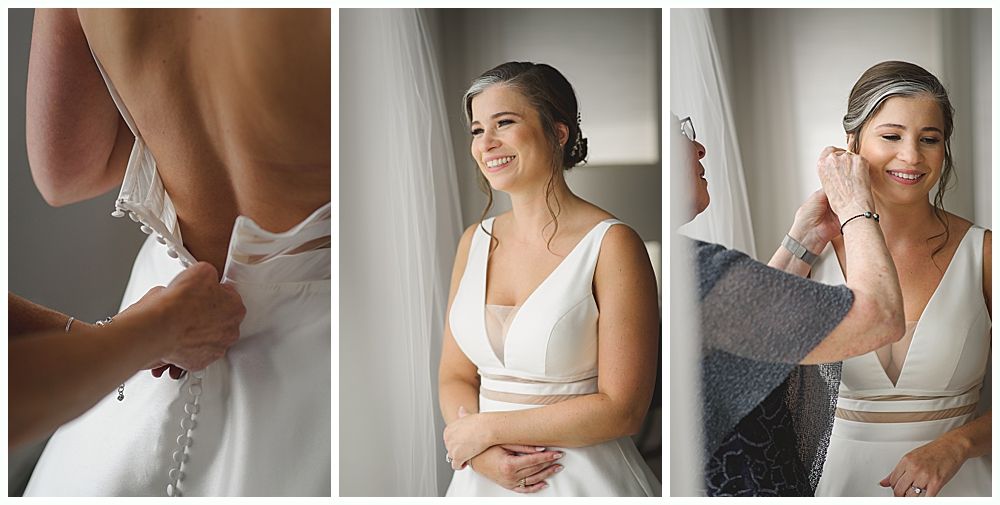 Bride in white dress with bridesmaids in red holding bouquets, smiling outdoors.