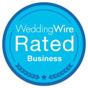 WeddingWire Rated Business badge: blue circle, white text, laurel leaf design.