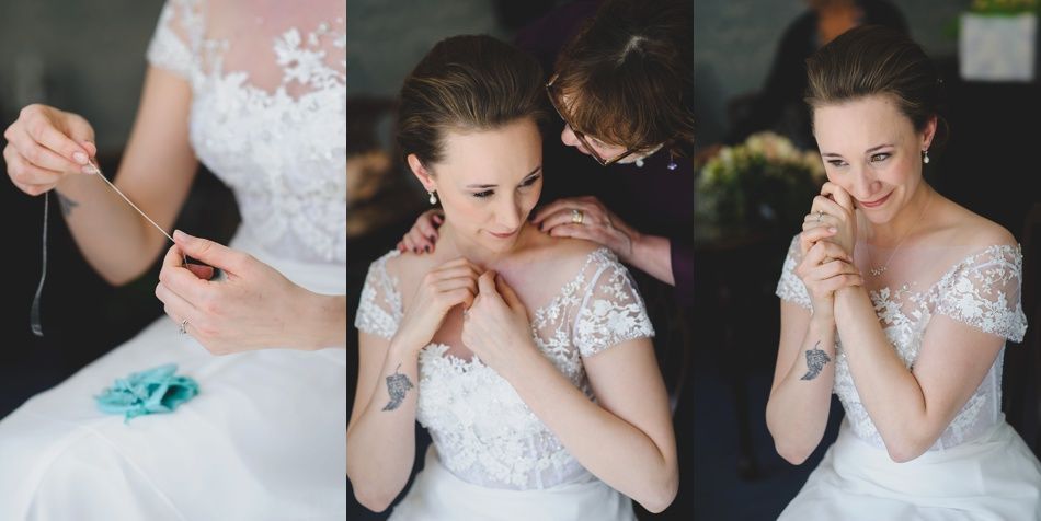 Couple on boardwalk by ocean, framed by beach plants under a blue sky with clouds.