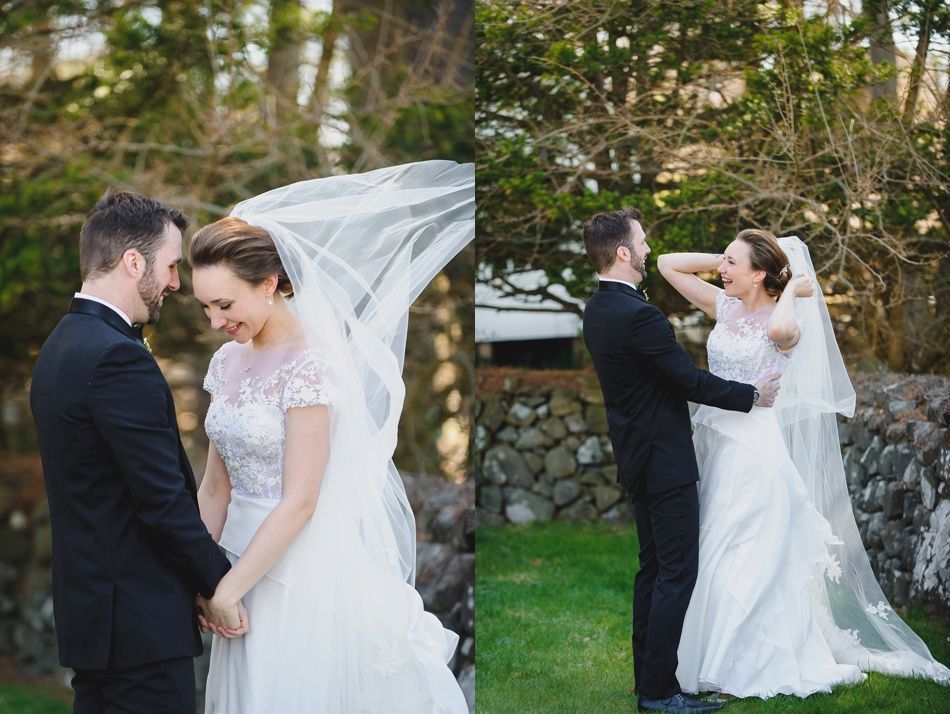 Bride with arms up, making a funny face, groom looking at his hand, cake cutting in background.