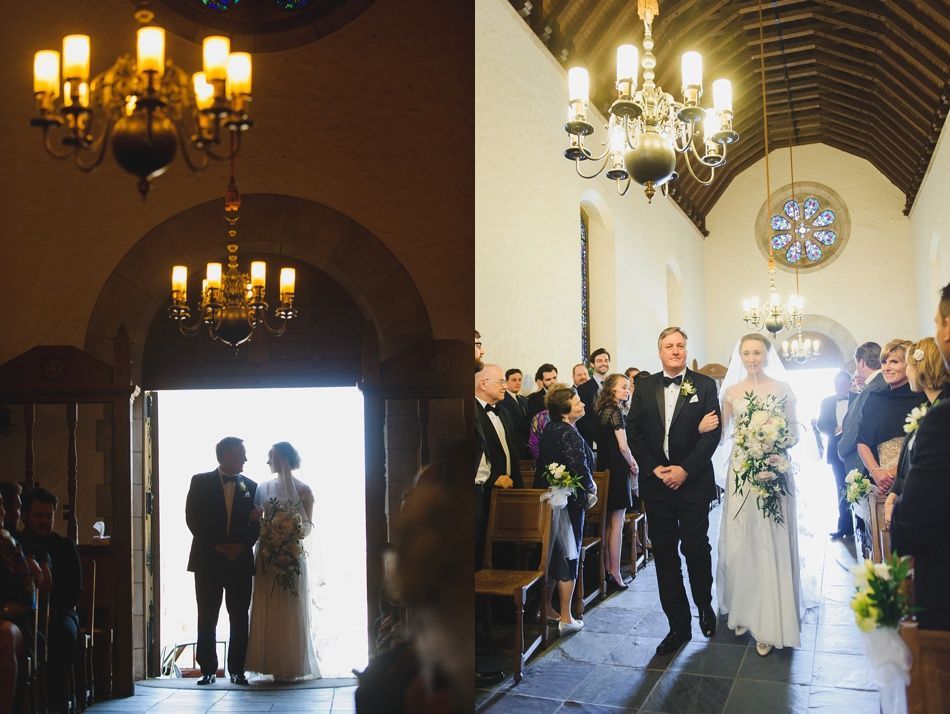 Bride with arms up, making a funny face, groom looking at his hand, cake cutting in background.