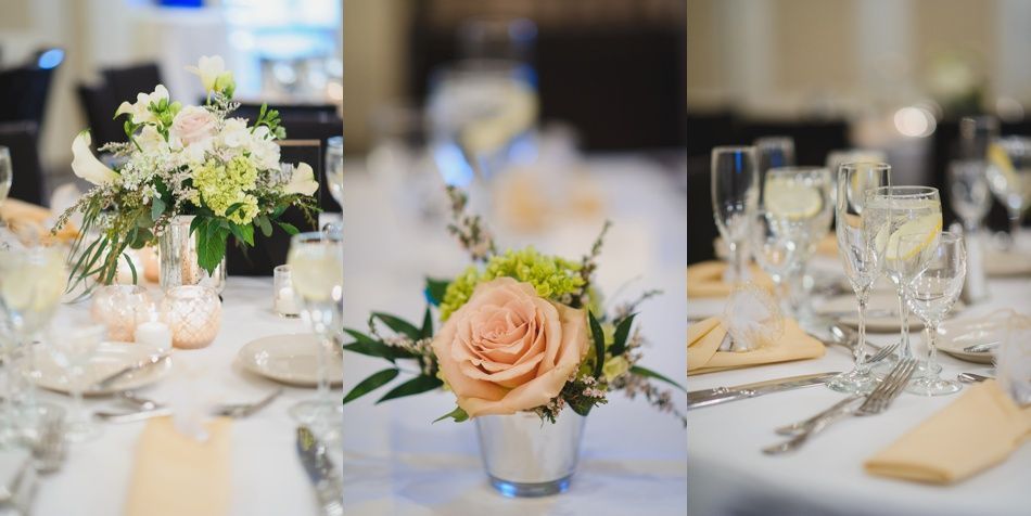 Bride with arms up, making a funny face, groom looking at his hand, cake cutting in background.