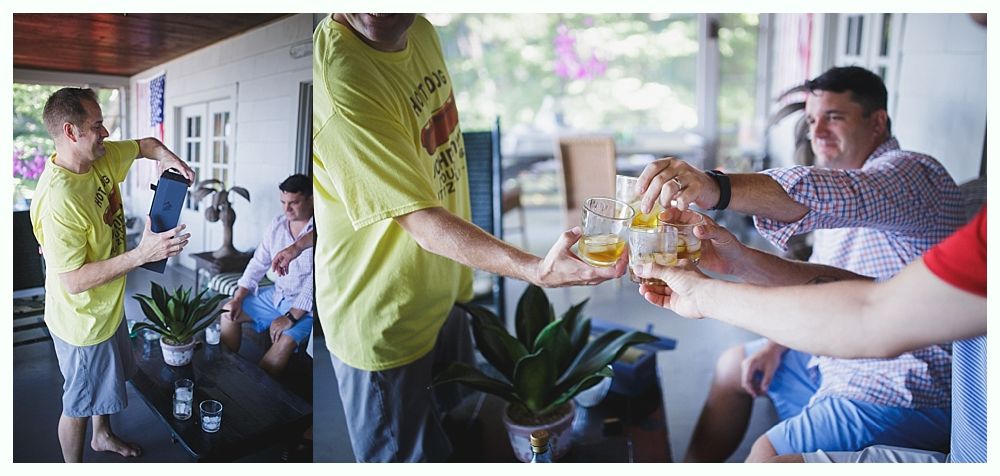 Bride with arms up, making a funny face, groom looking at his hand, cake cutting in background.