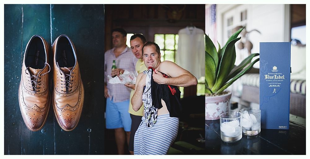 Bride with arms up, making a funny face, groom looking at his hand, cake cutting in background.