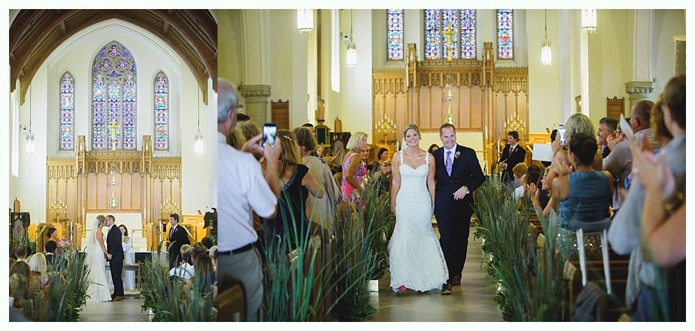 Bride with arms up, making a funny face, groom looking at his hand, cake cutting in background.