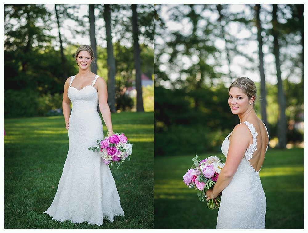 Bride with arms up, making a funny face, groom looking at his hand, cake cutting in background.
