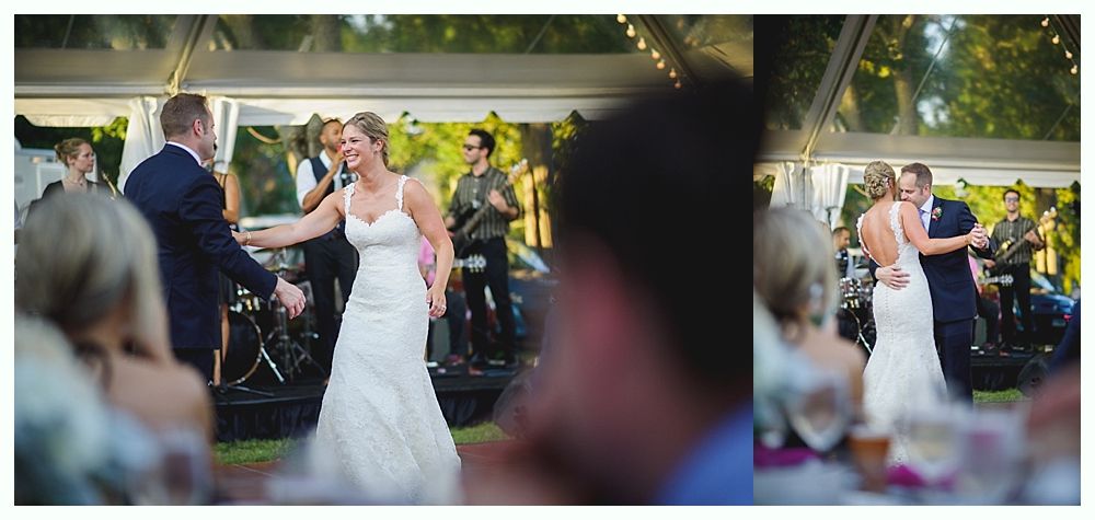 Bride with arms up, making a funny face, groom looking at his hand, cake cutting in background.