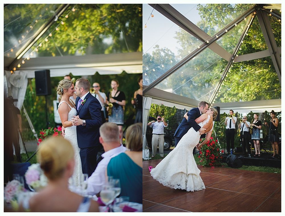Bride with arms up, making a funny face, groom looking at his hand, cake cutting in background.